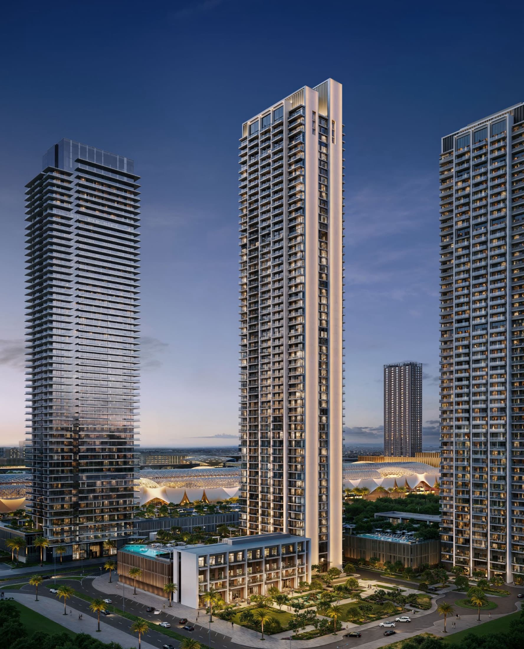 Valia at Dubai Creek Harbour — Emaar tower rising over the mixed-use podium at dusk